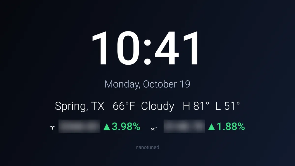Ambient dashboard on a TV showing the time, date, Spring TX weather, and TSLA and SpaceX tickers with prices blurred